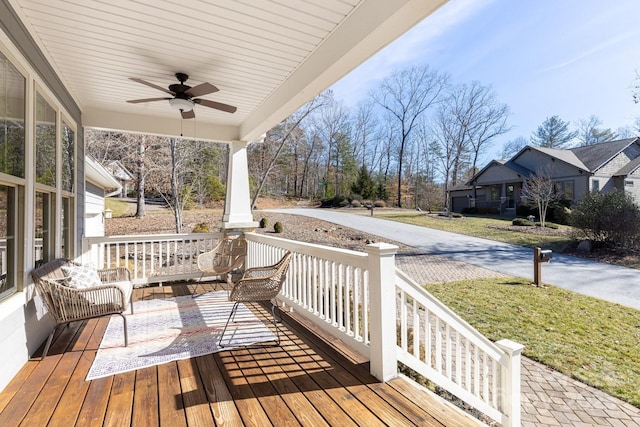 wooden deck featuring ceiling fan and covered porch