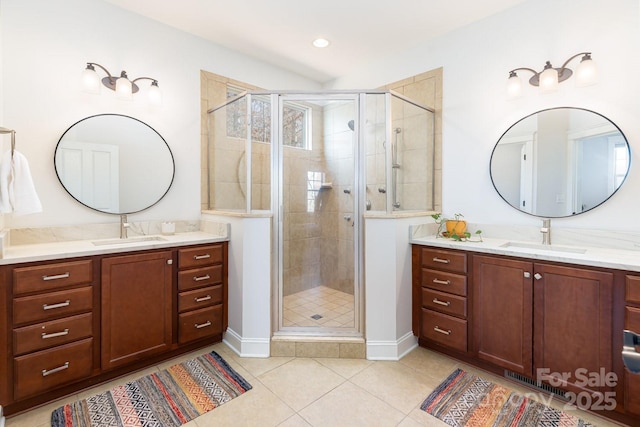 bathroom with tile patterned flooring, vanity, and an enclosed shower