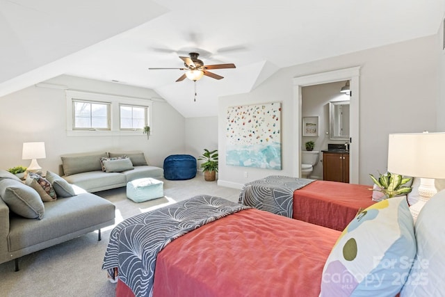 carpeted bedroom featuring lofted ceiling, connected bathroom, and ceiling fan