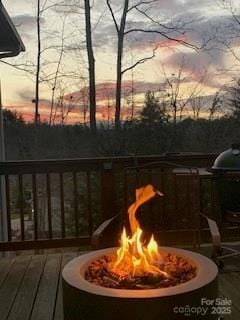 deck at dusk with an outdoor fire pit