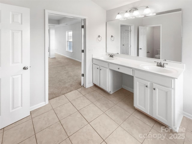 bathroom featuring tile patterned flooring, vanity, and toilet