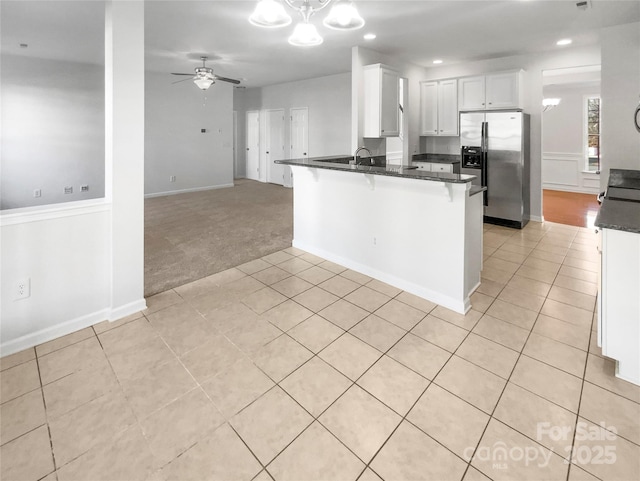 kitchen with white cabinets, a kitchen breakfast bar, light colored carpet, kitchen peninsula, and stainless steel refrigerator with ice dispenser