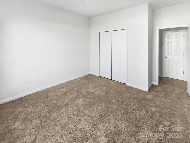 unfurnished bedroom with a closet and carpet