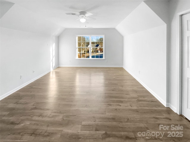 additional living space featuring ceiling fan, lofted ceiling, and dark hardwood / wood-style floors