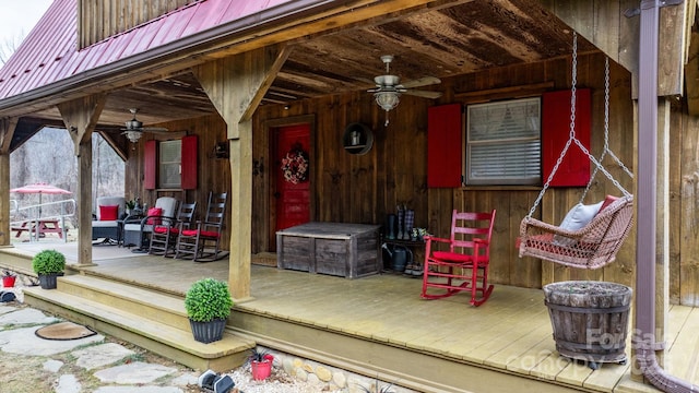 wooden terrace featuring ceiling fan and a porch