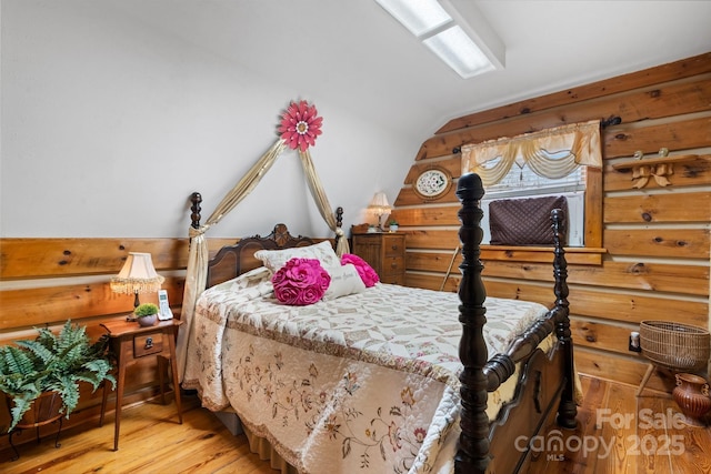 bedroom with hardwood / wood-style flooring and vaulted ceiling