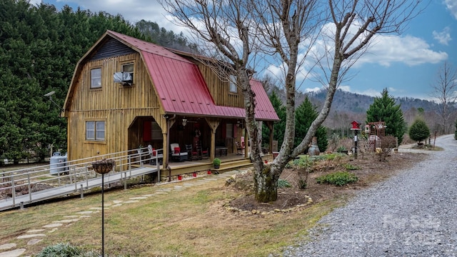 exterior space with a mountain view and covered porch