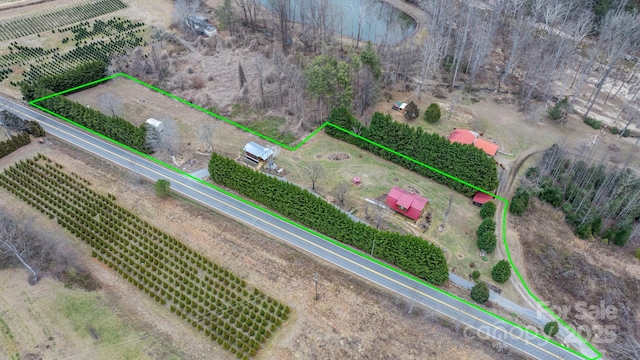 birds eye view of property with a rural view