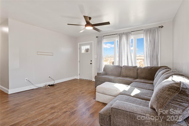 living room with dark wood-type flooring and ceiling fan