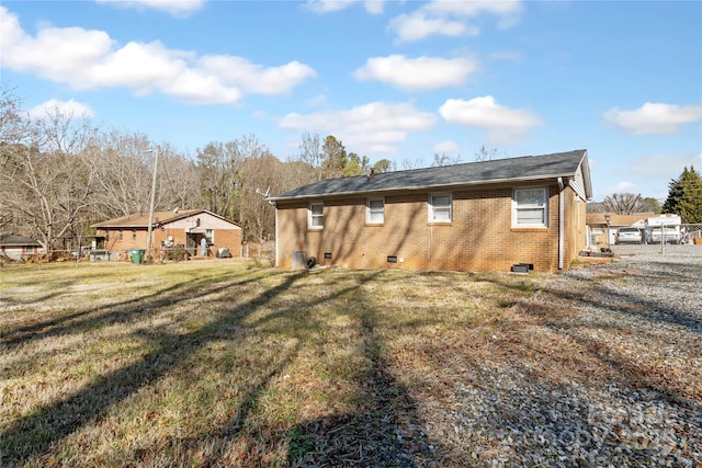 back of property with a lawn