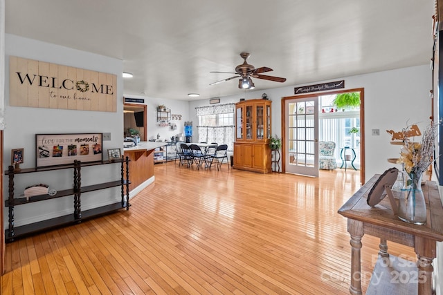 living room with ceiling fan and light hardwood / wood-style floors