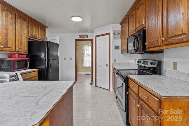 kitchen featuring sink and black appliances