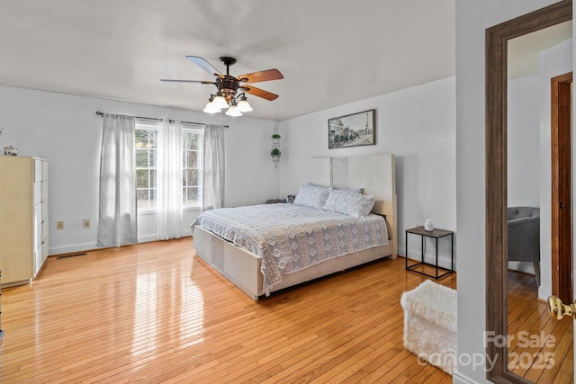 bedroom with ceiling fan and light hardwood / wood-style floors