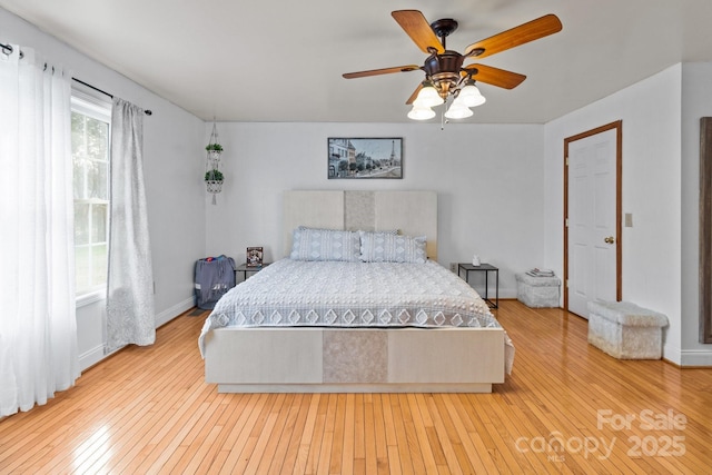 bedroom with wood-type flooring and ceiling fan