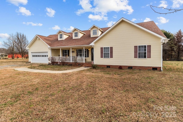 new england style home with a porch, a garage, and a front yard