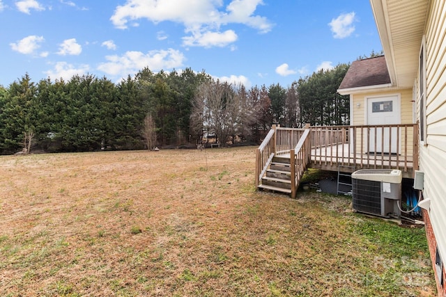 view of yard with a deck and central air condition unit