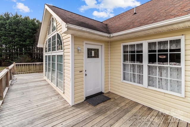 view of exterior entry with a deck