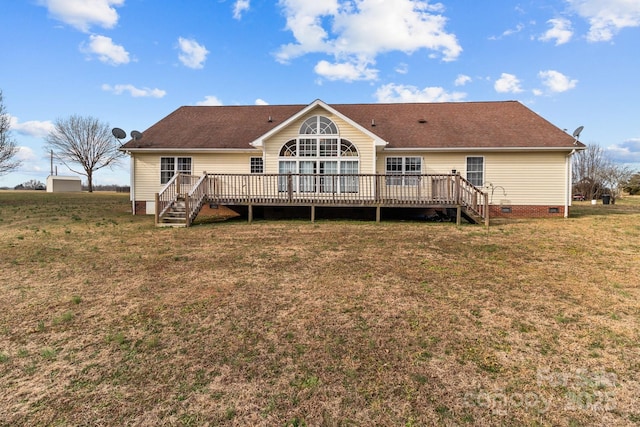 rear view of house featuring a lawn and a deck