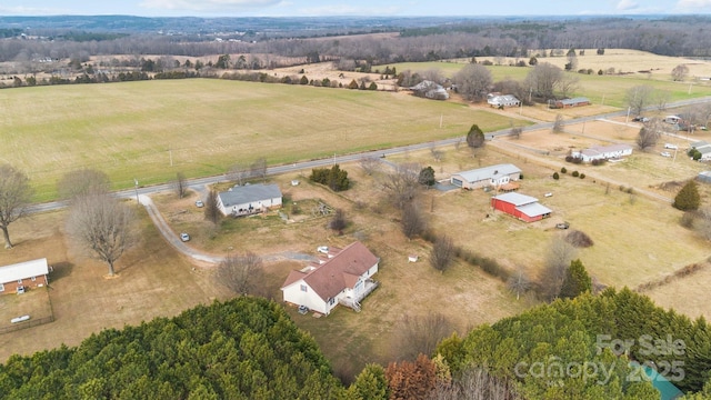 birds eye view of property with a rural view