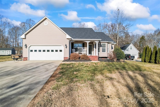 view of front of house featuring a porch, a garage, and a front yard