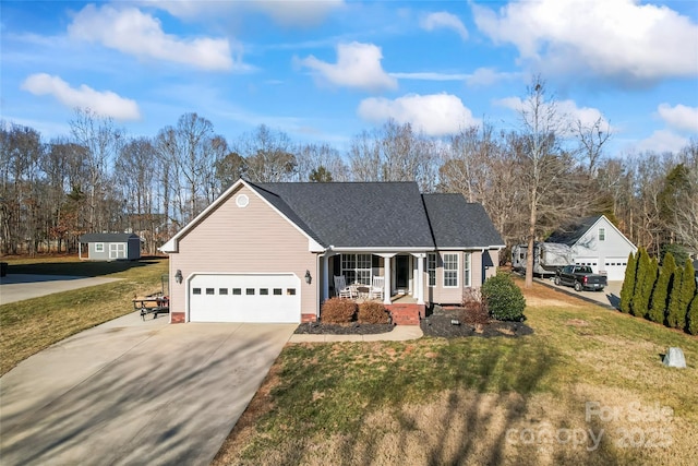 view of front of home featuring a garage, a front yard, and covered porch