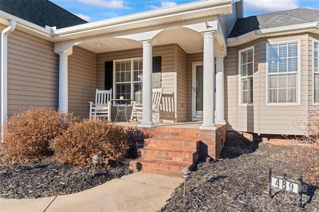 view of exterior entry with a porch