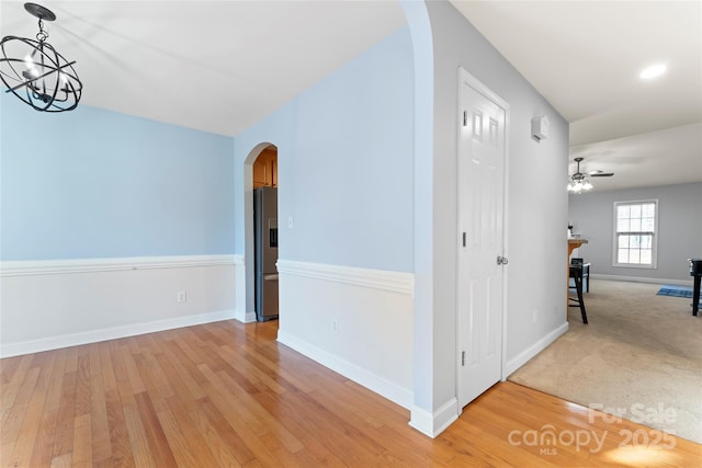 interior space with light hardwood / wood-style floors and a notable chandelier