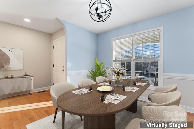 dining area featuring an inviting chandelier and wood-type flooring