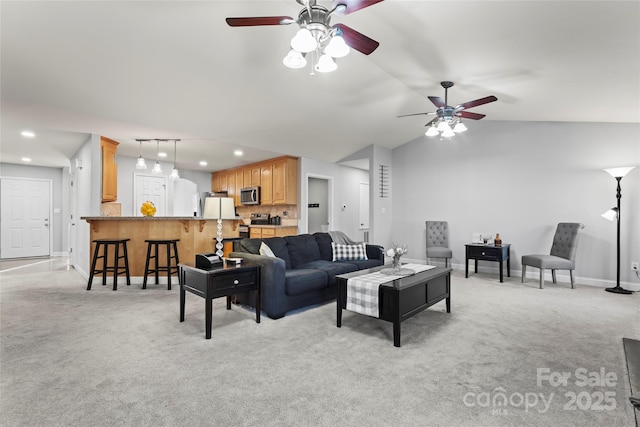 living room featuring ceiling fan, light colored carpet, and vaulted ceiling