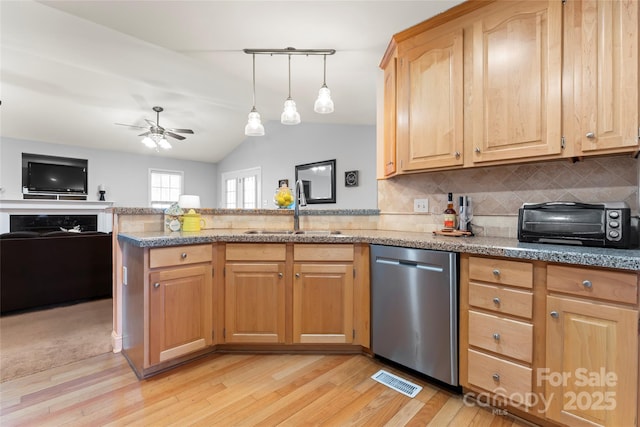 kitchen with lofted ceiling, sink, stainless steel dishwasher, kitchen peninsula, and light hardwood / wood-style floors