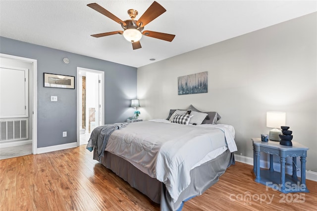 bedroom with hardwood / wood-style flooring and ceiling fan