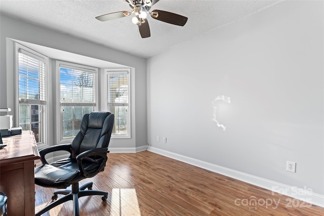 office area featuring ceiling fan, hardwood / wood-style floors, and a textured ceiling