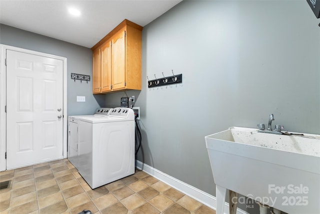 laundry room featuring cabinets, sink, and independent washer and dryer