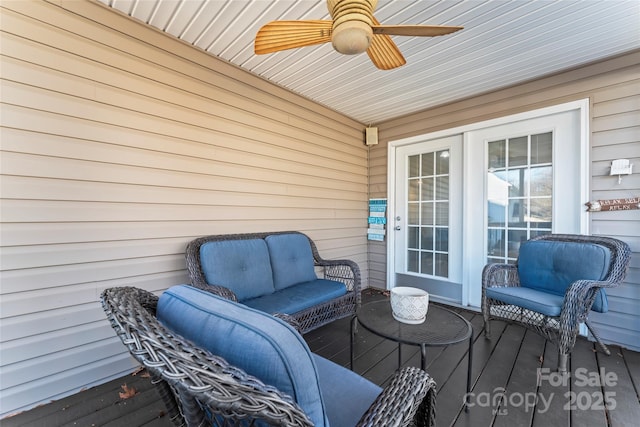 wooden deck with an outdoor living space