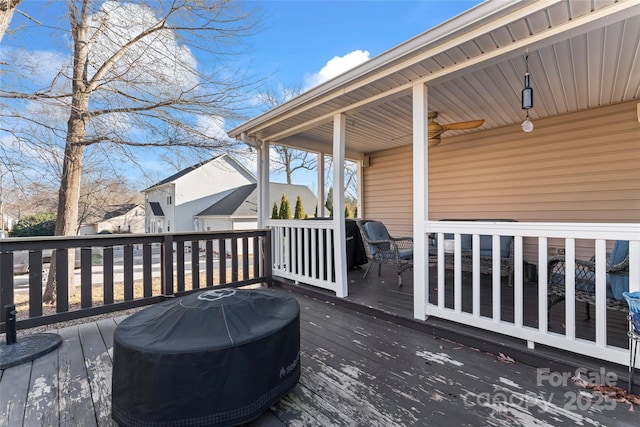 wooden terrace featuring ceiling fan and grilling area