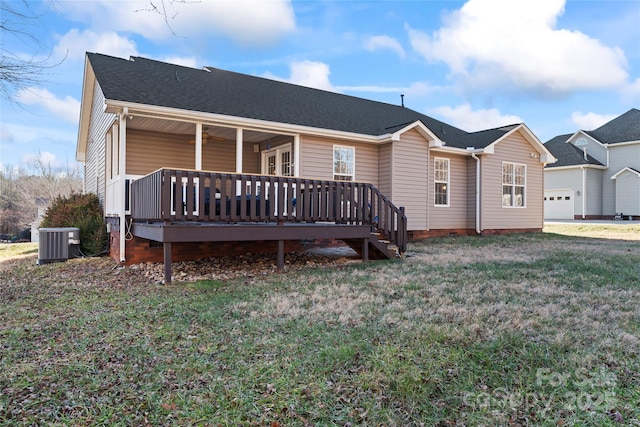 view of front facade featuring a wooden deck, central AC unit, and a front yard