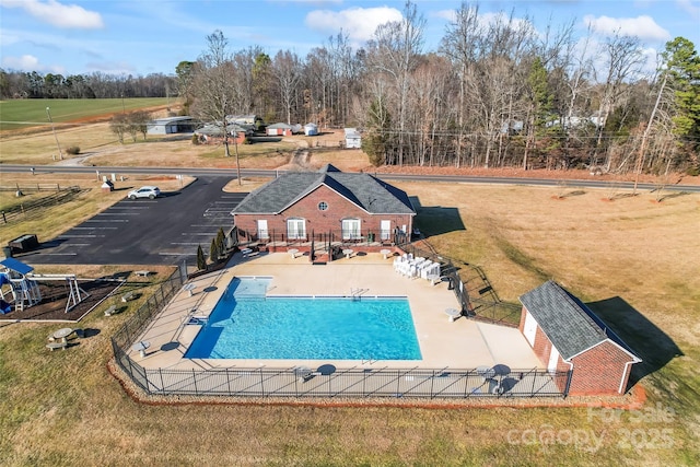 view of swimming pool with a lawn and a patio area