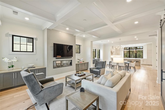 living room featuring visible vents, coffered ceiling, and beamed ceiling