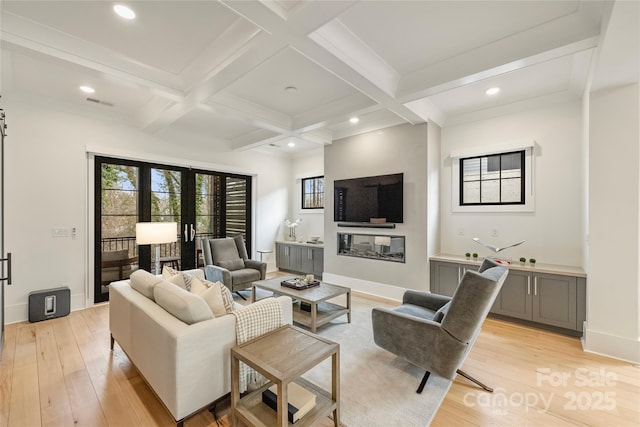 living area with light wood finished floors, coffered ceiling, and beam ceiling