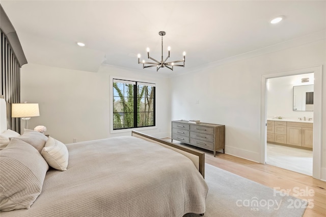 bedroom with ornamental molding, a sink, light wood-style flooring, and baseboards