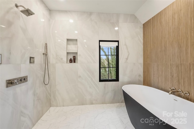 full bath with a freestanding bath, a marble finish shower, and tile walls