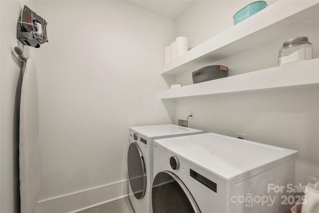 clothes washing area featuring laundry area and washing machine and clothes dryer