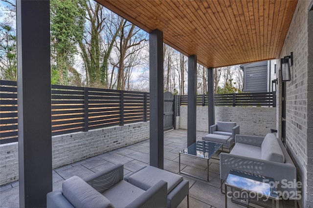 view of patio with fence private yard, a gate, and outdoor lounge area