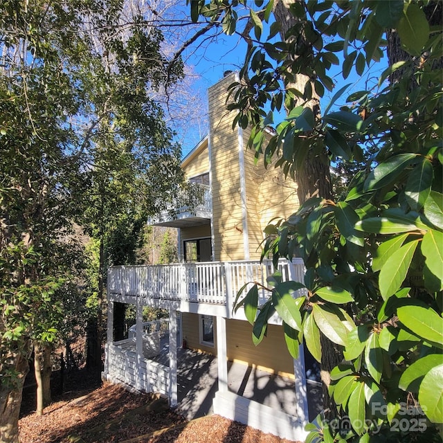 rear view of house featuring a wooden deck