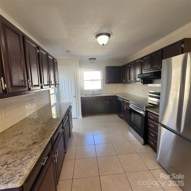 kitchen with light tile patterned flooring, sink, light stone counters, crown molding, and appliances with stainless steel finishes