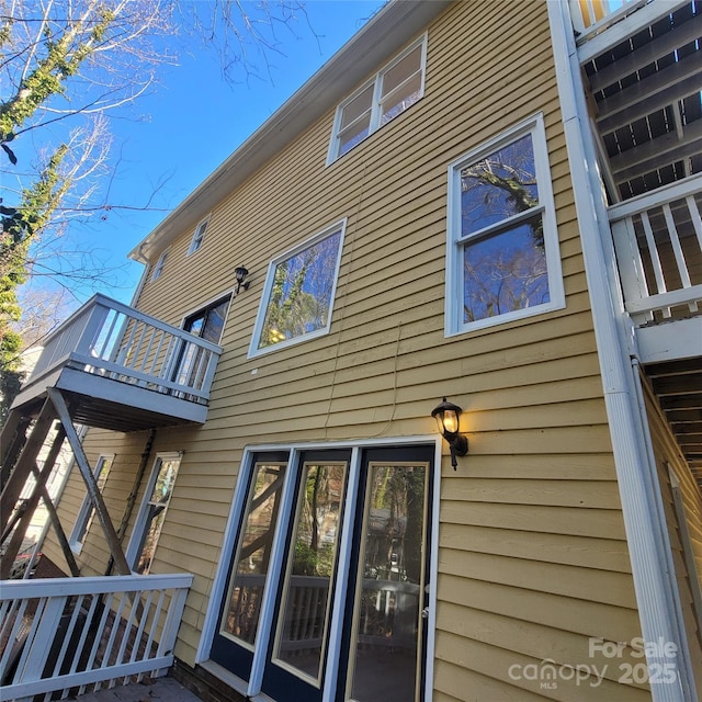 back of house with a balcony