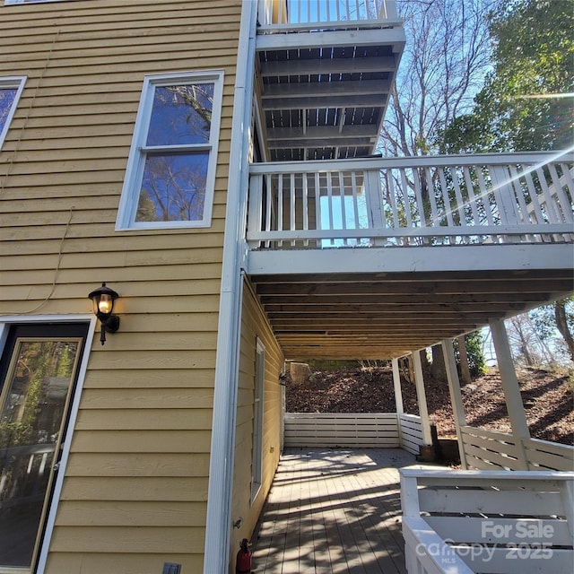 view of property exterior with a wooden deck