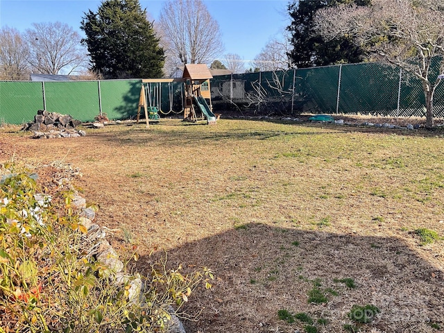 view of yard with a playground and fence