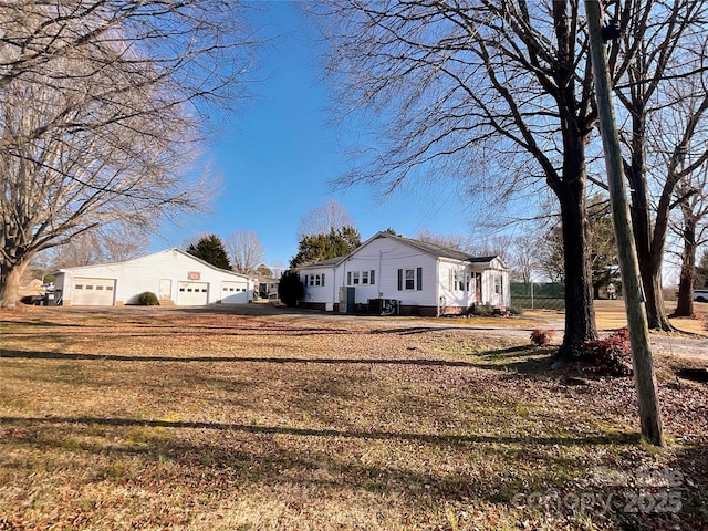 view of property exterior featuring a garage and a lawn