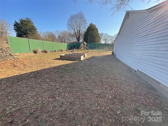 view of yard with a fenced backyard and a vegetable garden